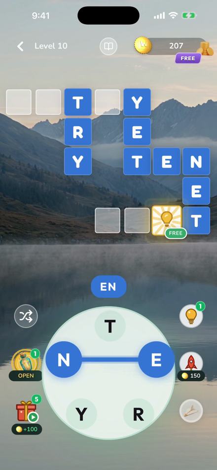 Wordmere gameplay: a crossword grid above the letter wheel, mid-swipe, over a mountain-lake world
